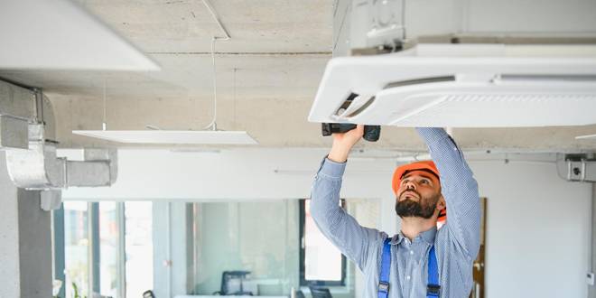 tech servicing an AC